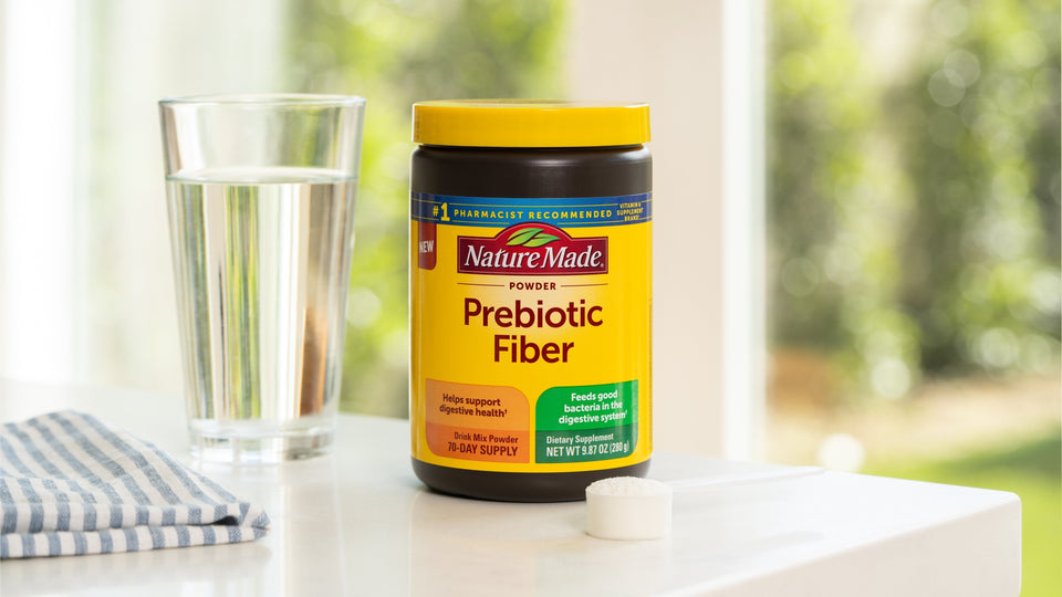 Nature Made Prebiotic Fiber Powder with a glass of water