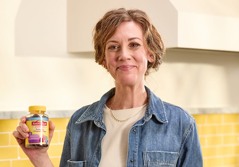 Woman holding Probiotics + Prebiotic Fiber Gummies