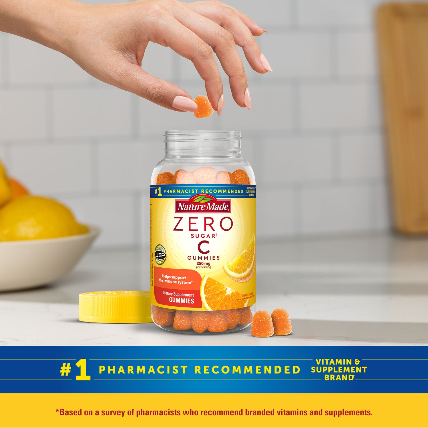 Zero Sugar‡ Vitamin C Gummies 250 Mg Per Serving | Nature Made Zero Sugar C Gummies bottle with a hand picking up a gummy, set against a kitchen background.